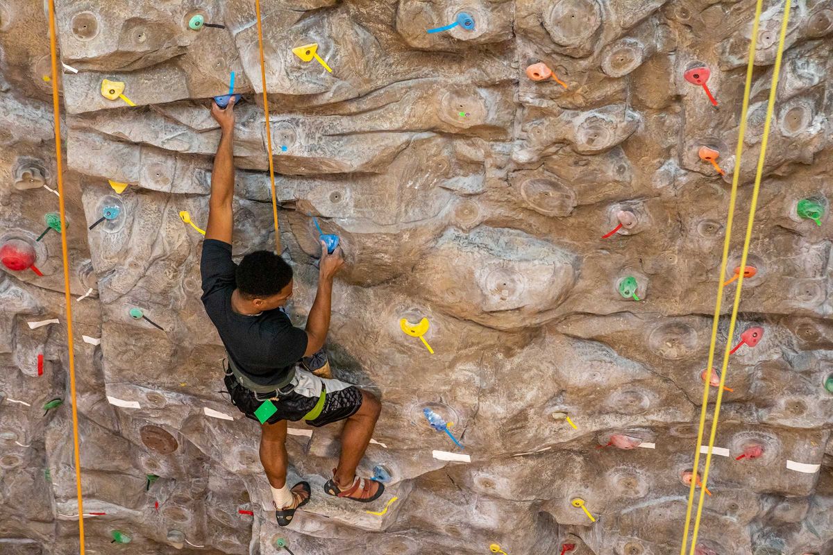 Student ascends climbing wall
